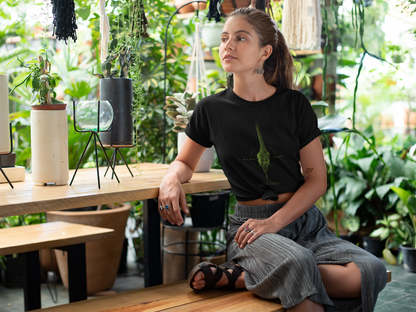woman wearing a Black graphic T-shirt featuring detailed green vine snake artwork with Silent Unseen typography