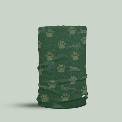 Green Tucktribe neck gaiter with leopard paw print pattern  on a light gray background