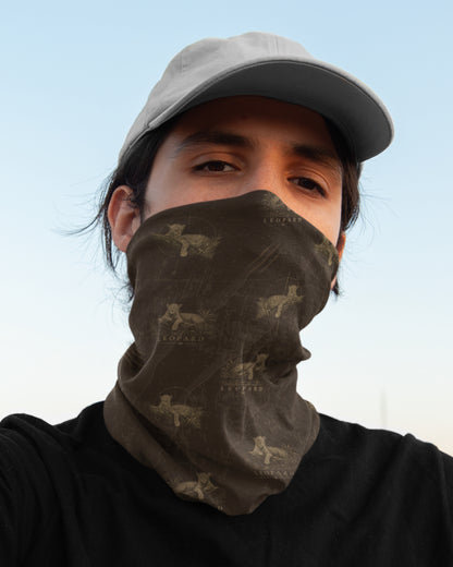 man wearing a tucktribe brown Leopard wildlife neck gaiter with repeating leopard pattern inspired by wildlife photography