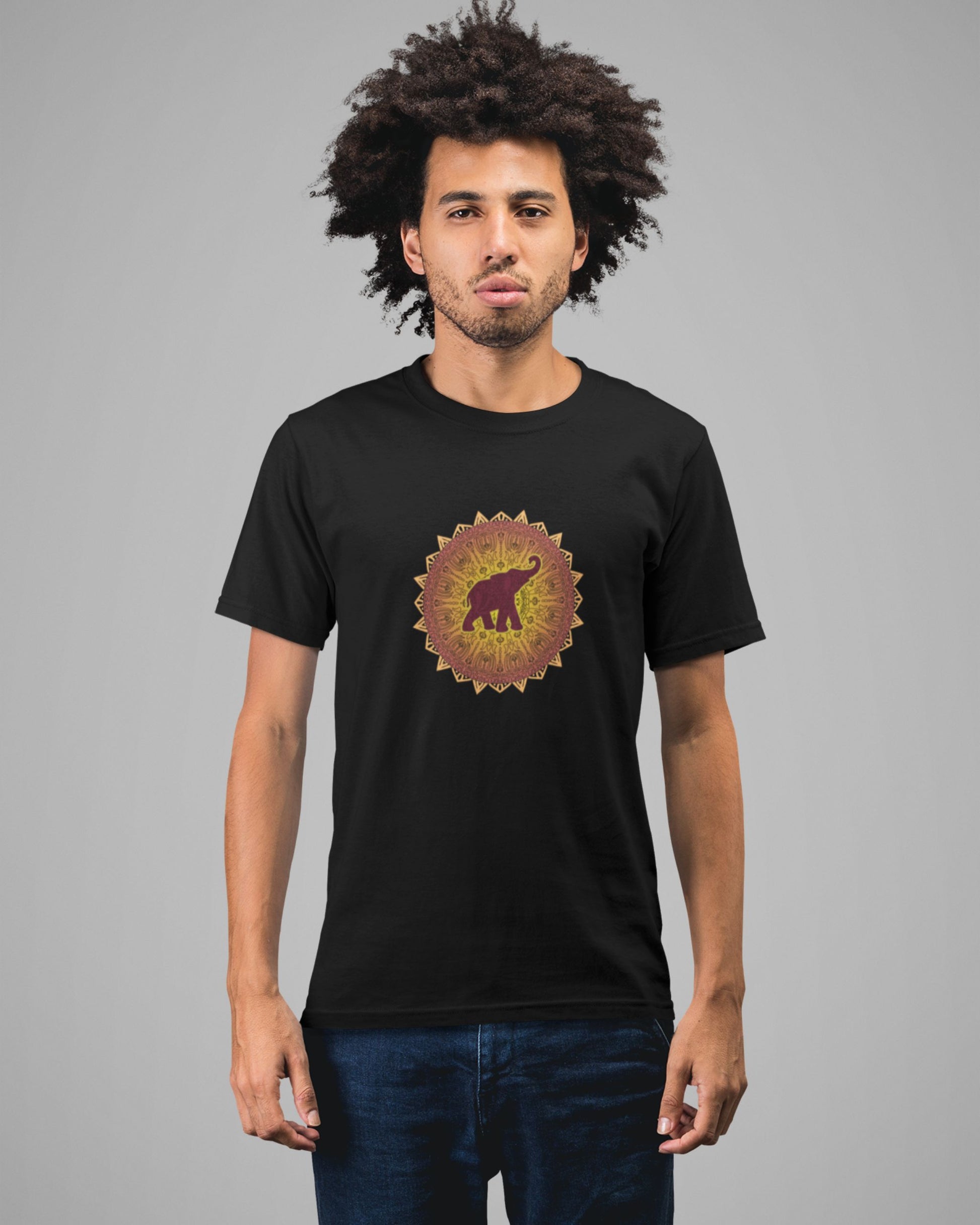 Man wearing a black tucktribe t-shirt with a colorful mandala elephant design on a gray background