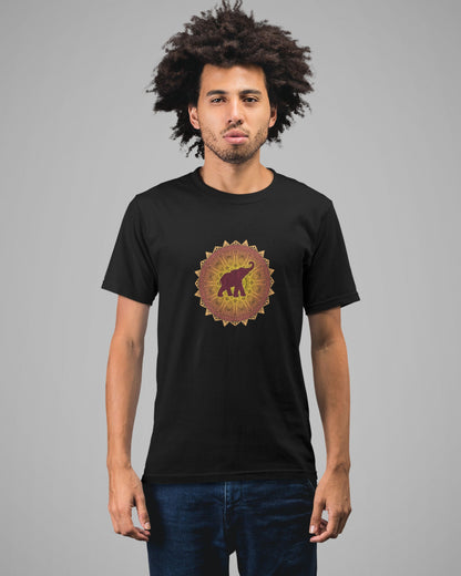 Man wearing a black tucktribe t-shirt with a colorful mandala elephant design on a gray background