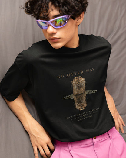 Person wearing a black tucktribe t-shirt with a graphic design of otter and purple sunglasses against a gray background