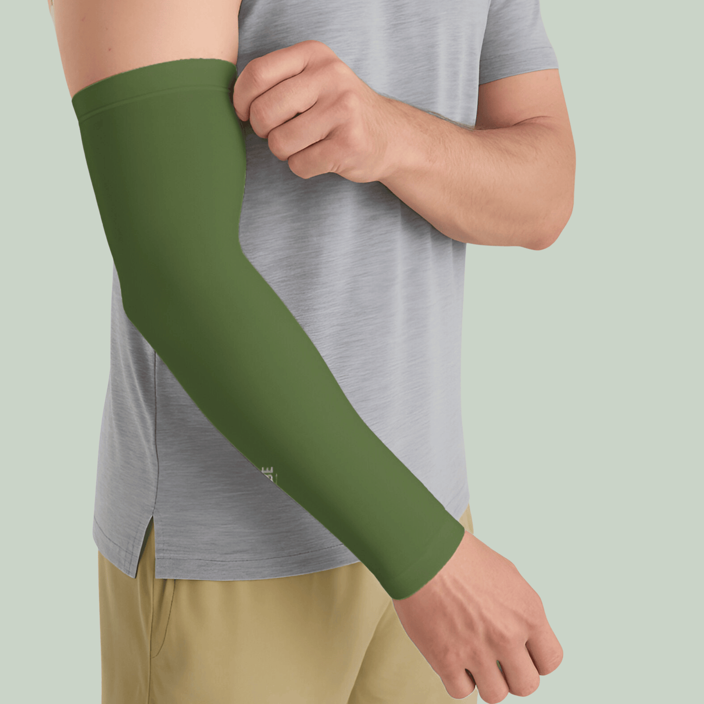 Person wearing a olive green arm sleeve on a light green background
