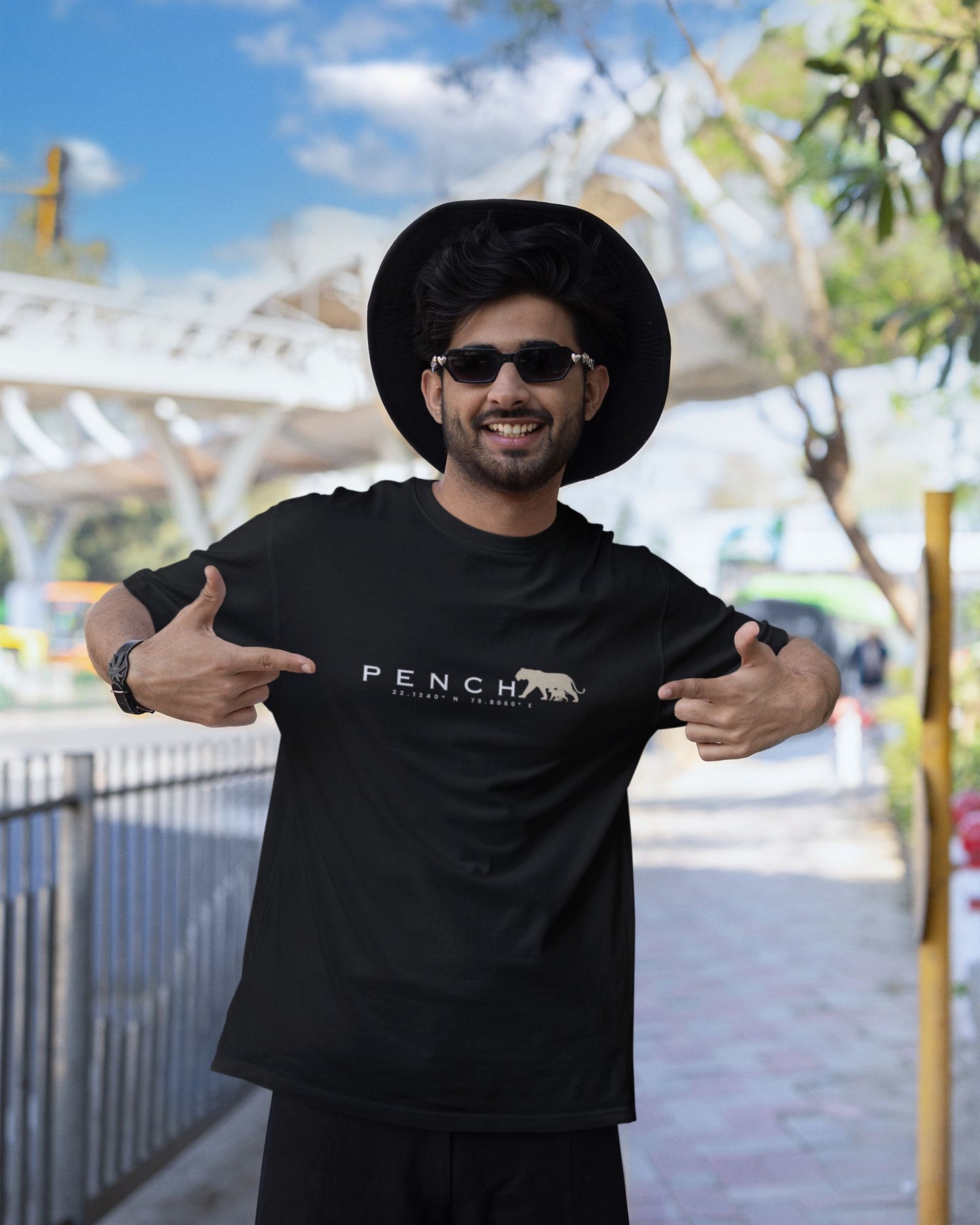 Man wearing Black t-shirt with PENCH typography and tiger silhouette print inspired by Pench Tiger Reserve
