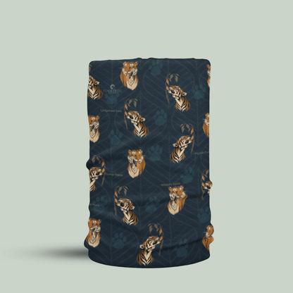 A tubular neck gaiter with a dark navy blue background, featuring a repeating pattern of golden-brown tiger heads and paw prints, displayed on a solid light sage green background.