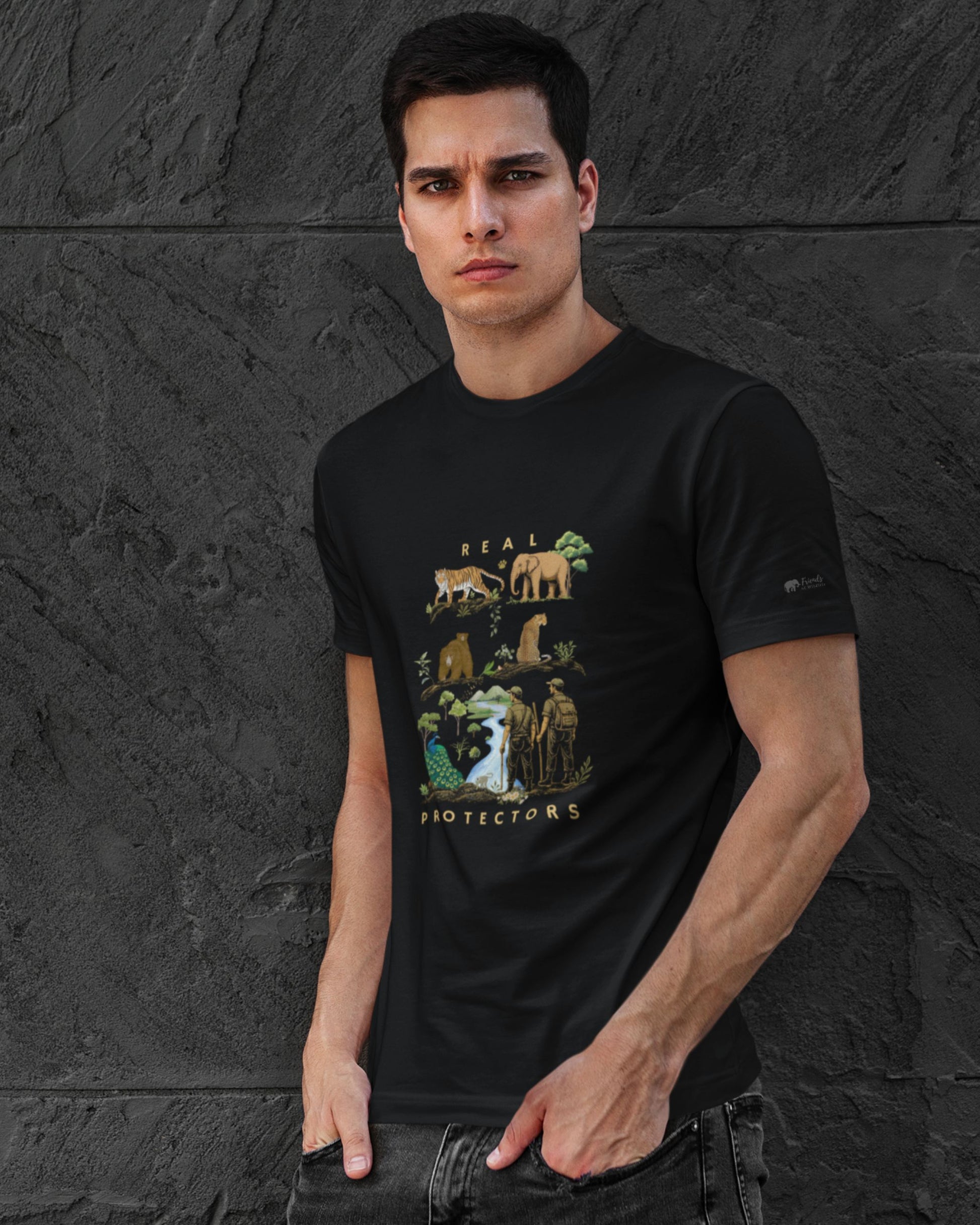Man wearing a black tucktribe t-shirt with a conservation graphic design against a dark stone wall.