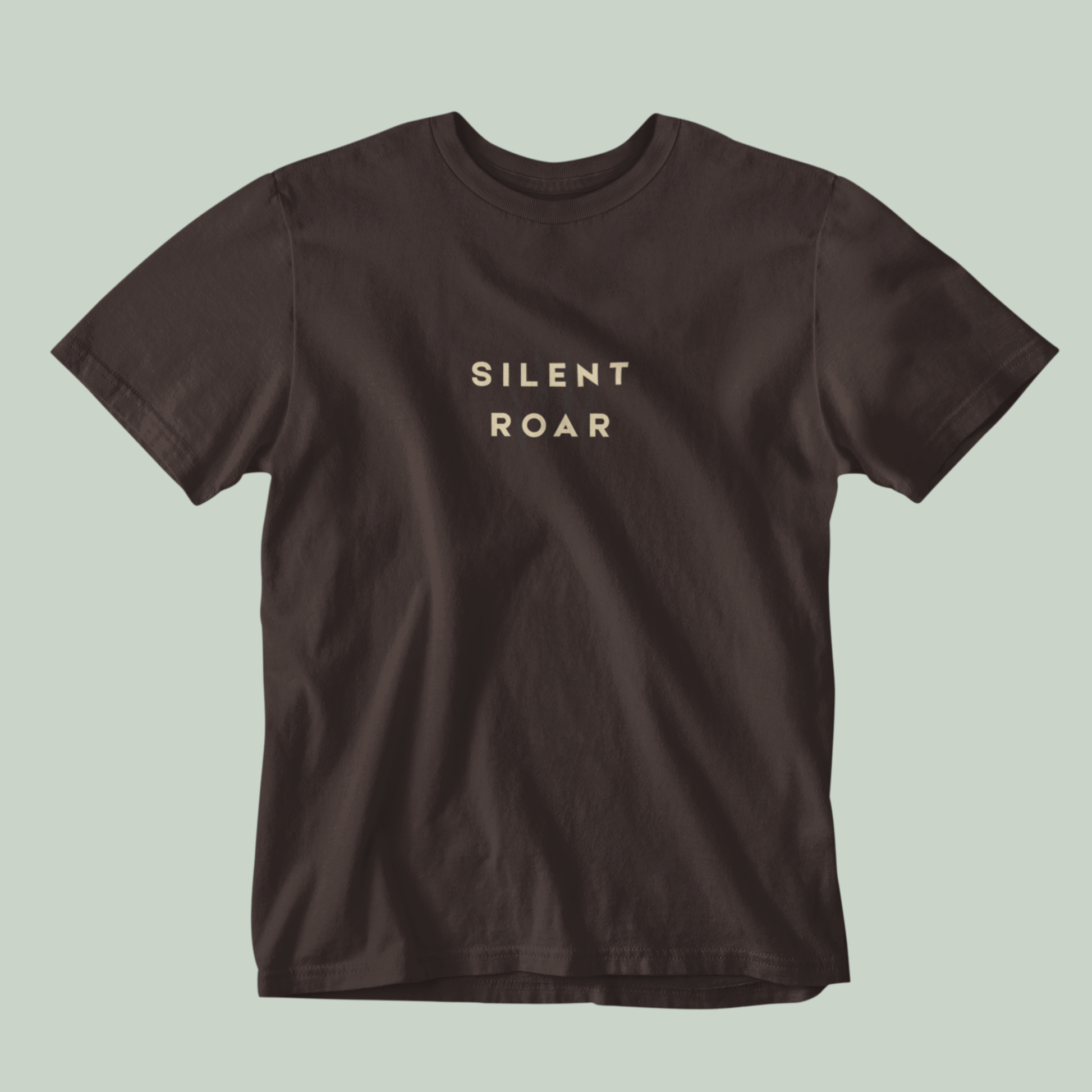Brown Tucktribe t-shirt with 'SILENT ROAR' text on a light green background
