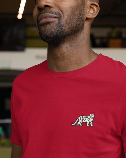 Person wearing red cotton stretch t-shirt with embroidered Snow Leopard wildlife design by Tucktribe