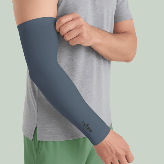 Person wearing a Tucktribe Steel gray sleeve on one arm with a light green background