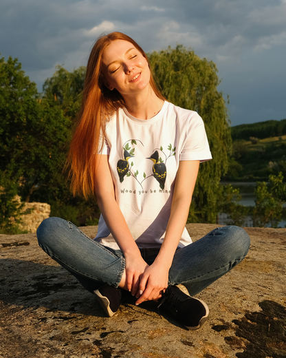Person sitting outdoors with trees and water in the background