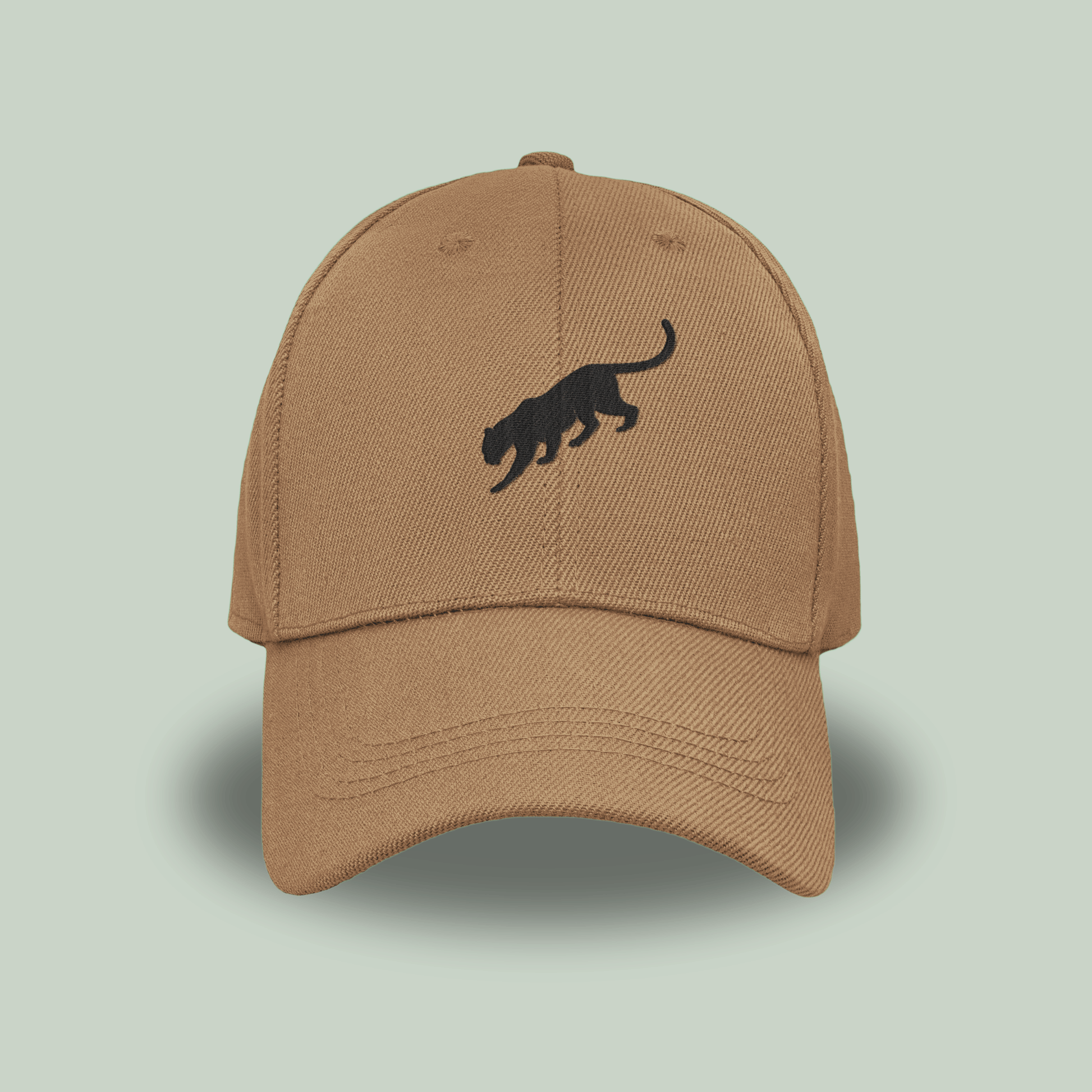 khaki tan tucktribe cap with a black panther logo on a light green background
