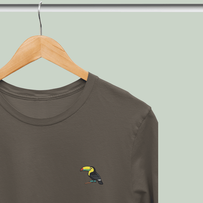 olive green tucktribe t-shirt with a toucan embroidery on a wooden hanger against a light green background