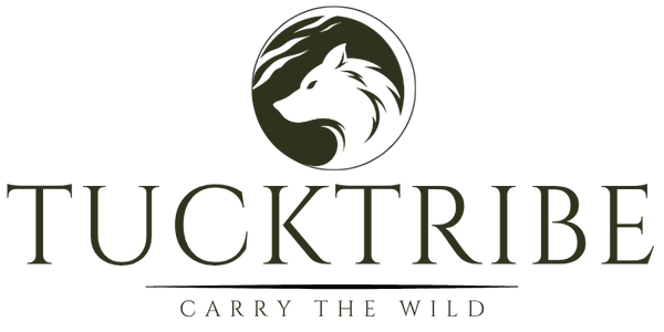 Tuck Tribe logo featuring a stylized wolf head inside a circular emblem above the brand name 'TUCKTRIBE' and the tagline 'CARRY THE WILD' on a white background.