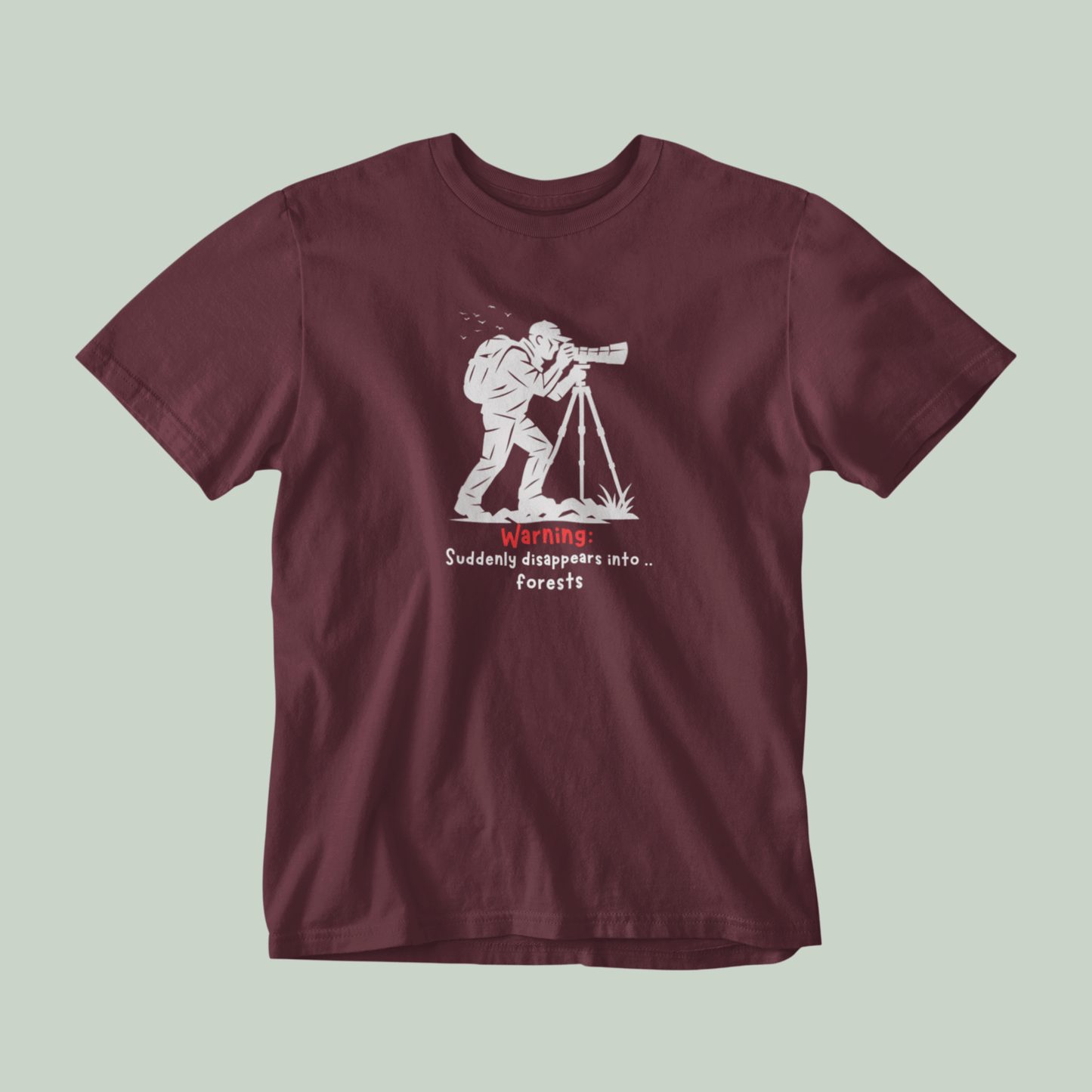 Maroon t-shirt with graphic design and text on a light gray background